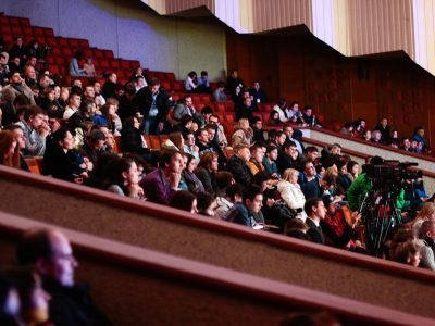 Engaged audience seated indoors, captured with a Canon camera. Ideal for event coverage visuals.